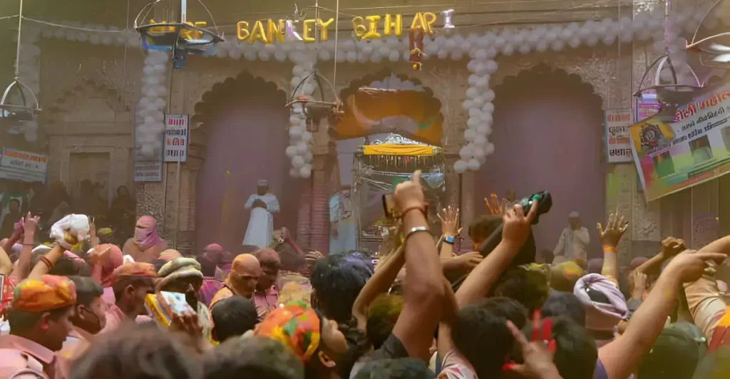 People celebrating Holi festival at Banke Bihari temple in Vrindavan, India